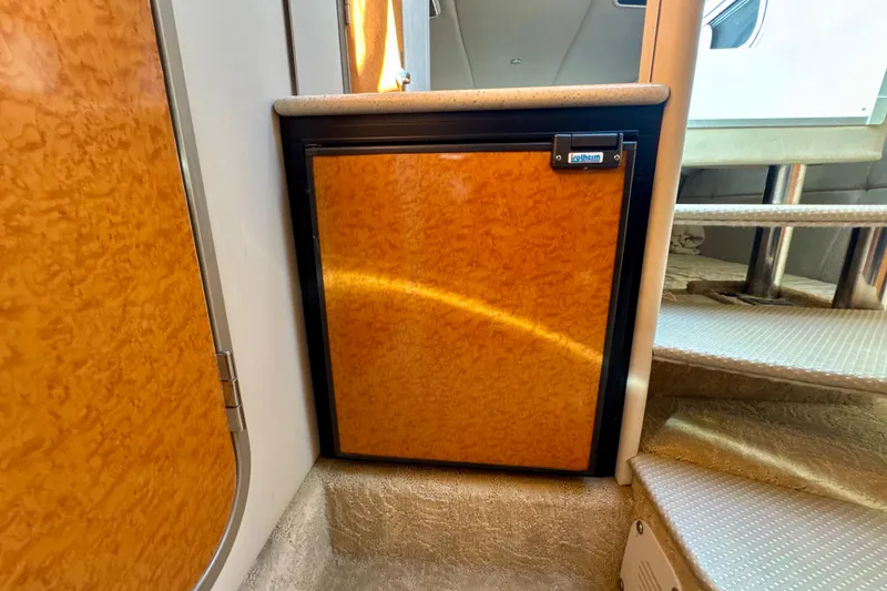 Slide: The Image of 2006 Formula 370 Super Sport interior with compact wooden cabinet and stairs. - 17