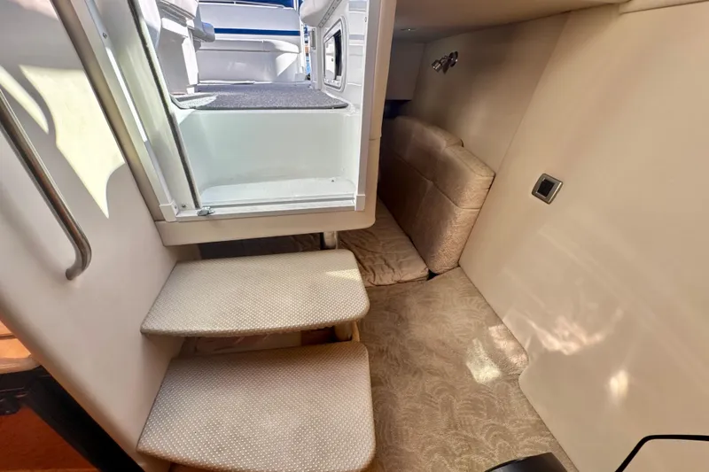 Slide: The Image of Interior cabin of 2006 Formula 370 Super Sport boat with stairs and seating area. - 18