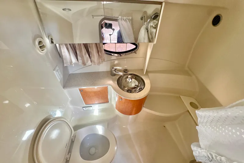 Slide: The Image of 2006 Formula 370 Super Sport boat bathroom with sink, toilet, and mirror. - 21