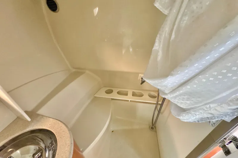 Slide: The Image of 2006 Formula 370 Super Sport bathroom interior with sink and shower curtain. - 22