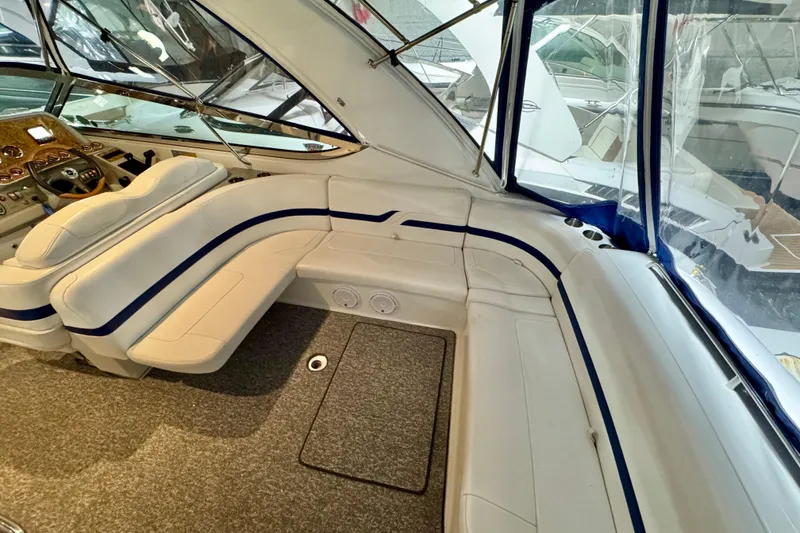 Slide: The Image of Interior of 2006 Formula 370 Super Sport boat with white seating and blue accents. - 25