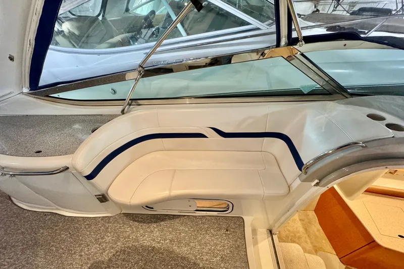 Slide: The Image of 2006 Formula 370 Super Sport boat interior with white seating and blue accents. - 28