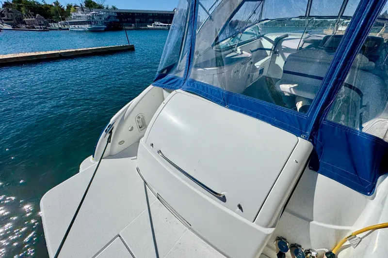Slide: The Image of 2006 Formula 370 Super Sport boat docked with blue canopy and clear waters. - 3