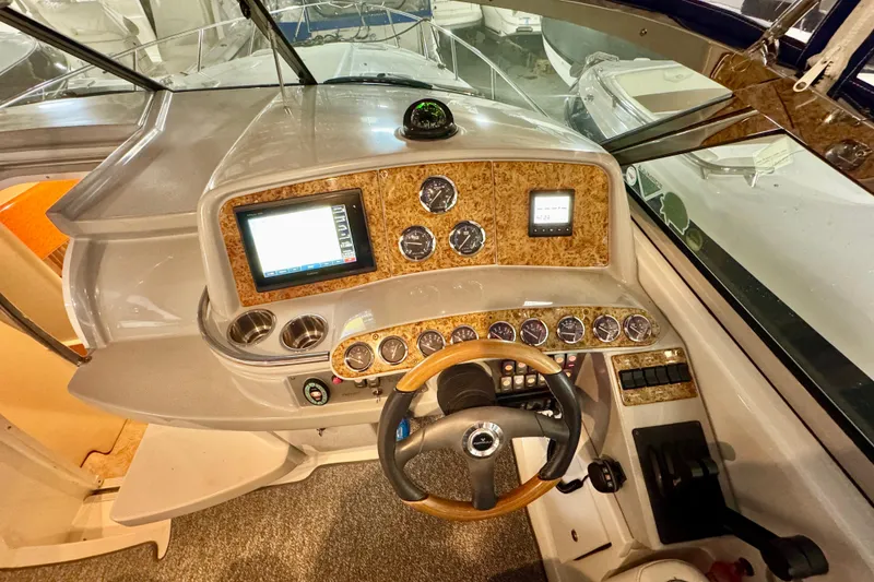 Slide: The Image of 2006 Formula 370 Super Sport boat dashboard with wood accents and modern controls. - 30