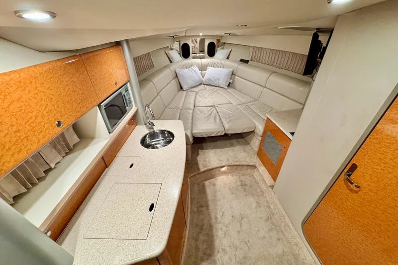Slide: The Image of Luxurious interior of 2006 Formula 370 Super Sport boat with cozy seating and kitchenette. - 32