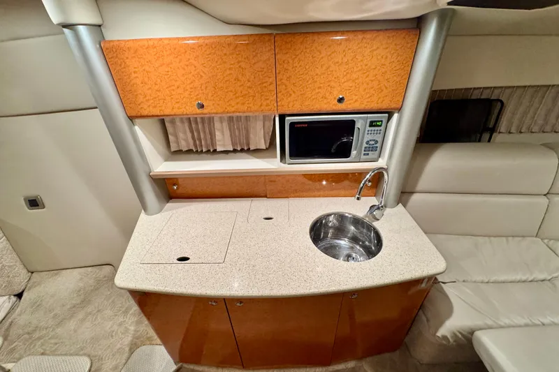 Slide: The Image of 2006 Formula 370 Super Sport yacht interior with kitchenette, sink, and microwave. - 34