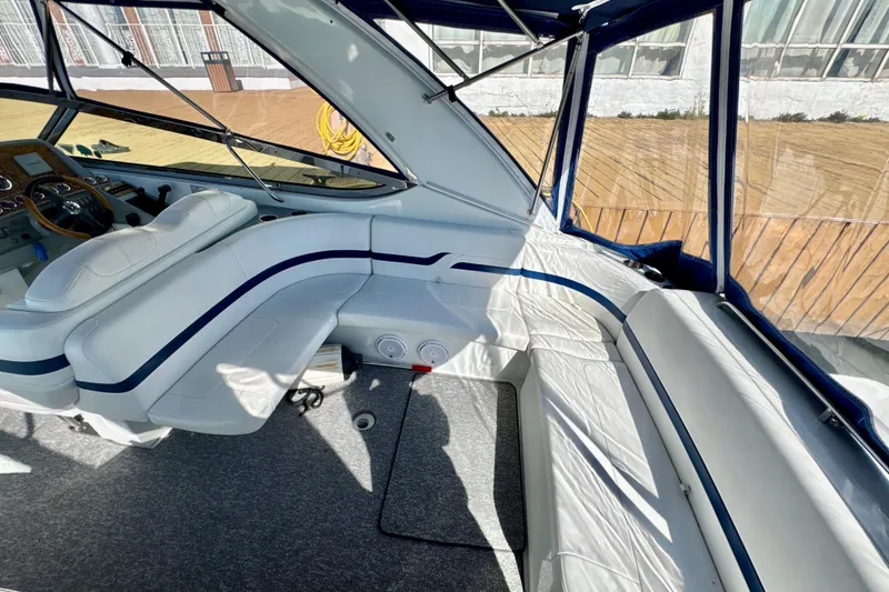 Slide: The Image of Interior of 2006 Formula 370 Super Sport boat with white seating and blue accents. - 4