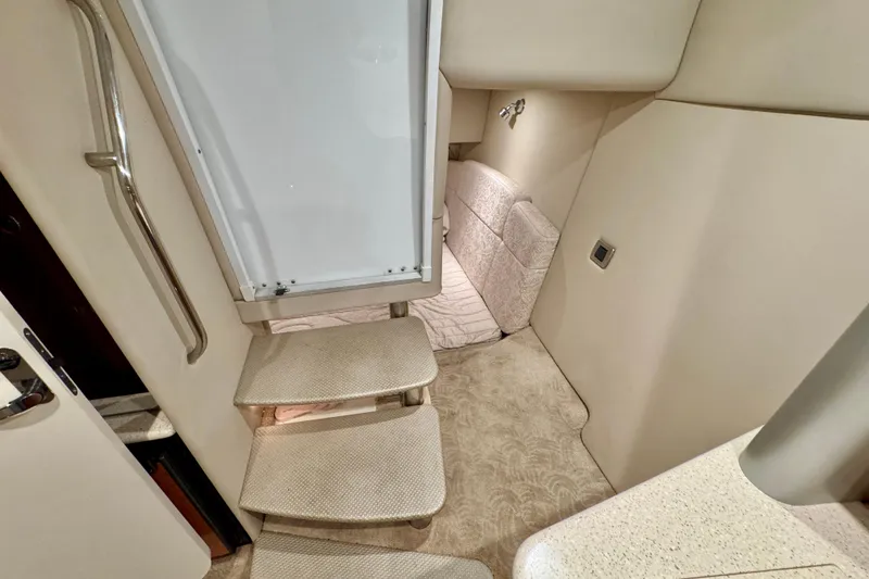 Slide: The Image of Interior of 2006 Formula 370 Super Sport boat, featuring stairs and cozy seating area. - 41