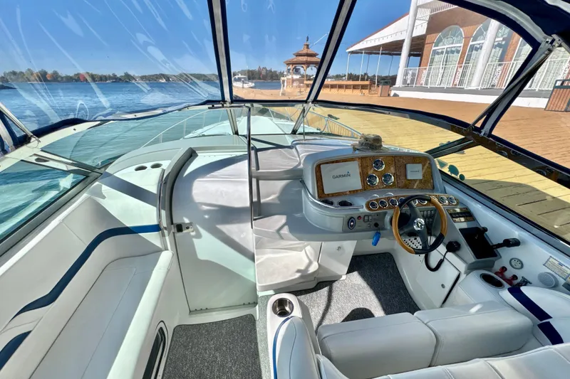 Slide: The Image of 2006 Formula 370 Super Sport boat interior with helm, steering wheel, and waterfront view. - 8