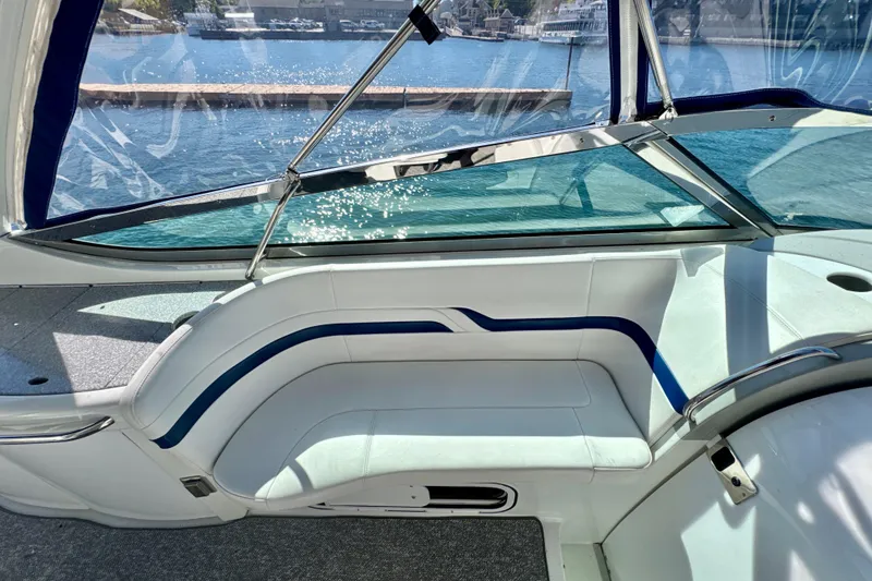 Slide: The Image of Interior of a 2006 Formula 370 Super Sport boat with white seating and blue accents. - 9
