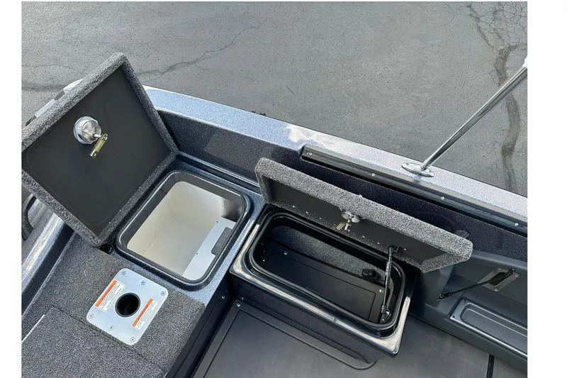 Slide: The Image of 2026 Lund 189 Pro-V GL boat storage compartments and rod holder on deck. - 10