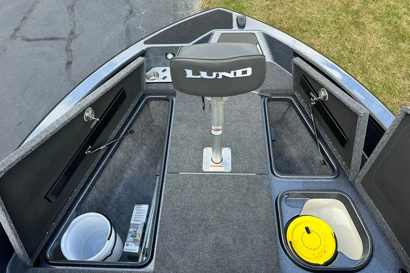 Slide: The Image of 2026 Lund 189 Pro-V GL boat interior with storage compartments and seating. - 13