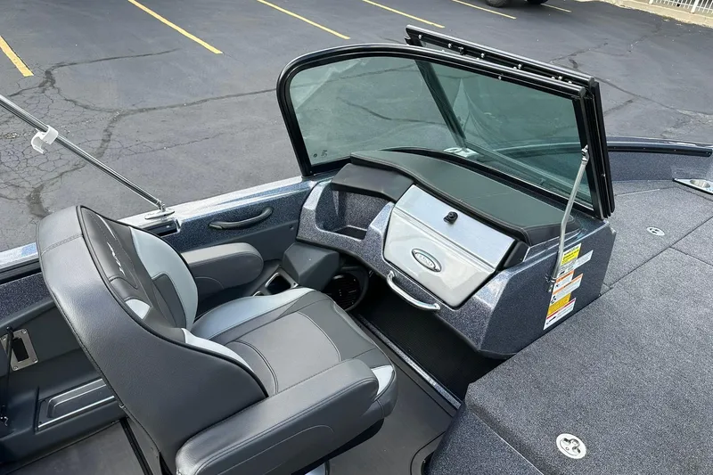 Slide: The Image of 2026 Lund 189 Pro-V GL boat interior with steering console and seating. - 18