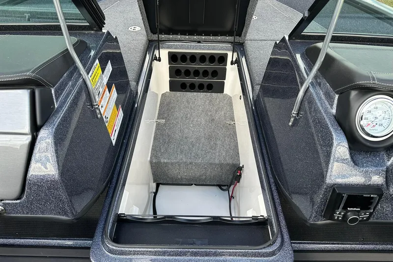 Slide: The Image of 2026 Lund 189 Pro-V GL boat interior storage compartment with gauge and control panel. - 19