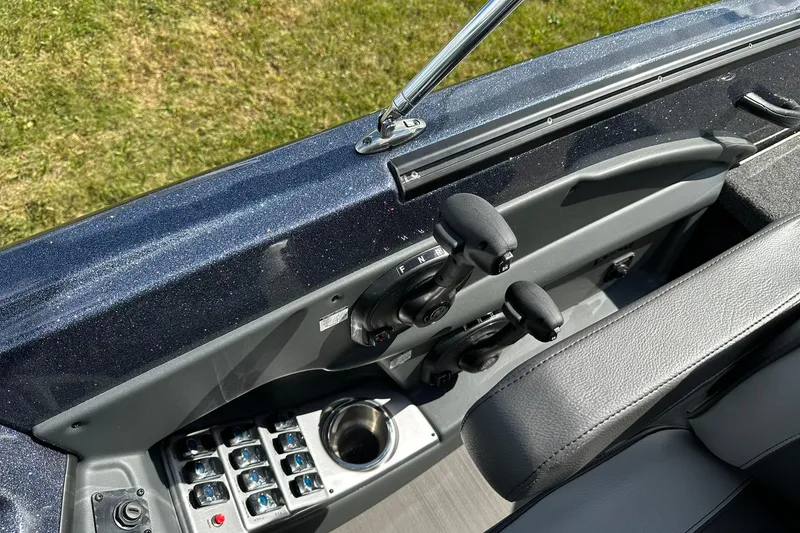 Slide: The Image of 2026 Lund 189 Pro-V GL boat interior with control panel and throttle levers. - 23