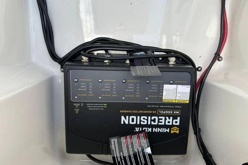 Slide: The Image of Battery charger in 2026 Lund 189 Pro-V GL boat, featuring Minn Kota Precision model. - 26