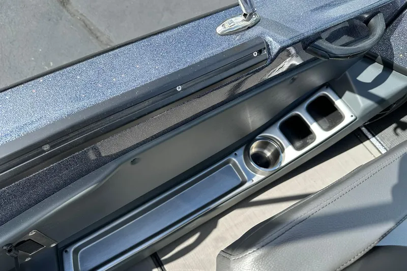 Slide: The Image of 2026 Lund 189 Pro-V GL boat interior with cup holders and storage compartments. - 27