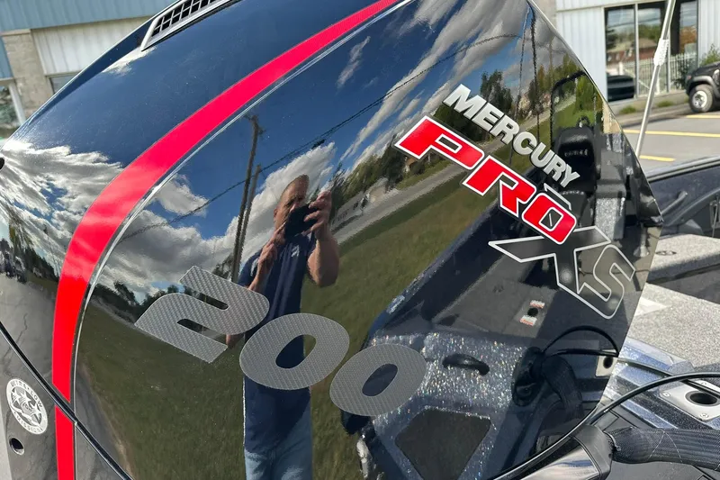 Slide: The Image of Mercury Pro XS 200 engine on 2026 Lund 189 Pro-V GL boat, reflecting sky and surroundings. - 28