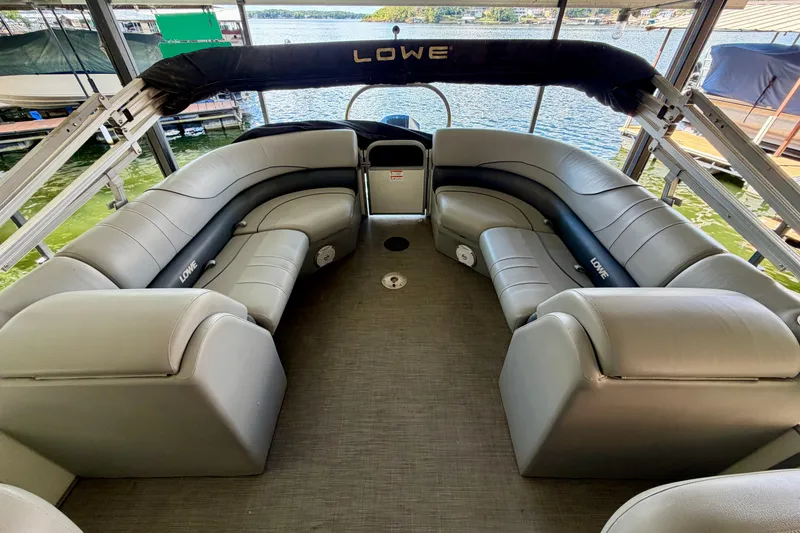 Slide: The Image of 2021 Lowe SS 270 Extended WT pontoon boat interior with spacious seating and lake view. - 11