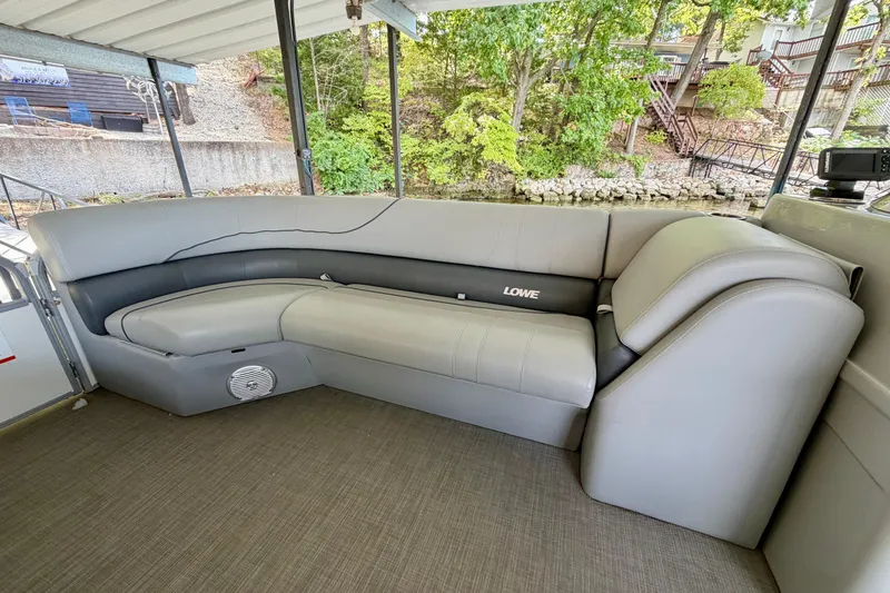 Slide: The Image of 2021 Lowe SS 270 Extended WT boat interior with gray seating and scenic outdoor view. - 12