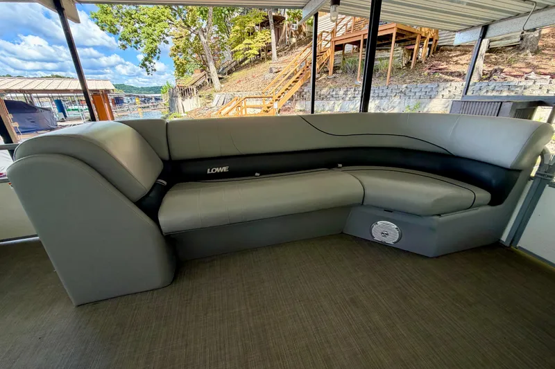 Slide: The Image of 2021 Lowe SS 270 Extended WT boat interior with gray seating and scenic lake view. - 13