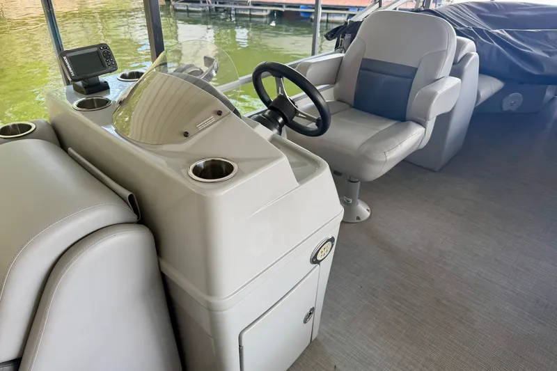 Slide: The Image of 2021 Lowe SS 270 Extended WT boat interior with steering wheel and seating. - 17
