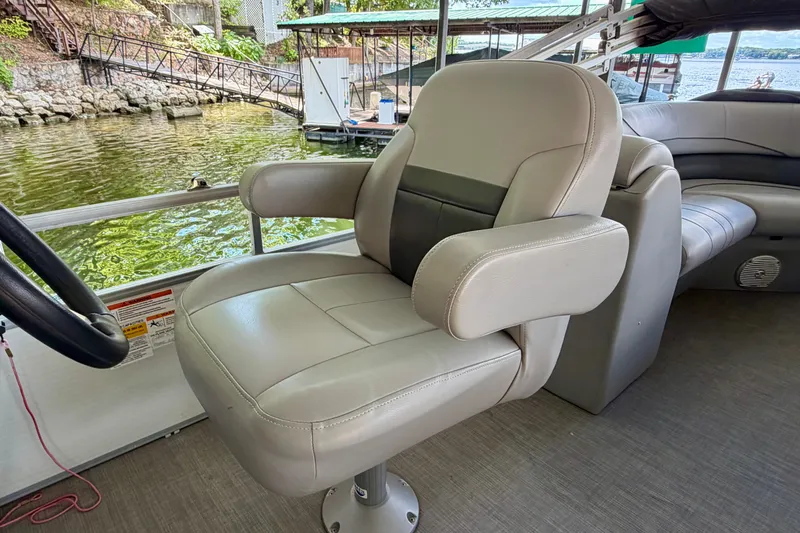 Slide: The Image of Captain's chair on 2021 Lowe SS 270 Extended WT boat, near a scenic lakeside dock. - 18