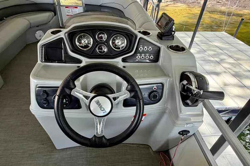 Slide: The Image of Steering console of 2021 Lowe SS 270 Extended WT boat with gauges and controls. - 19