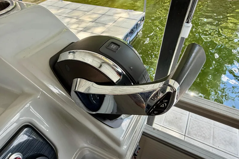 Slide: The Image of Throttle control of 2021 Lowe SS 270 Extended WT boat, near water. - 24