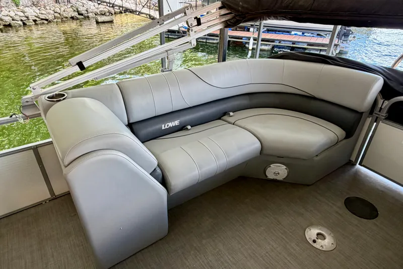 Slide: The Image of Luxurious seating on 2021 Lowe SS 270 Extended WT pontoon boat, docked by the water. - 26