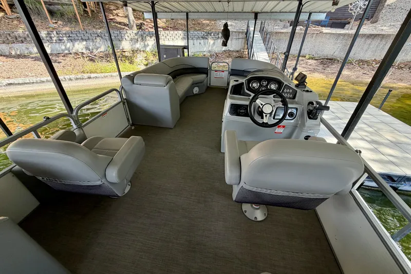 Slide: The Image of 2021 Lowe SS 270 Extended WT pontoon boat interior with helm and seating. - 27