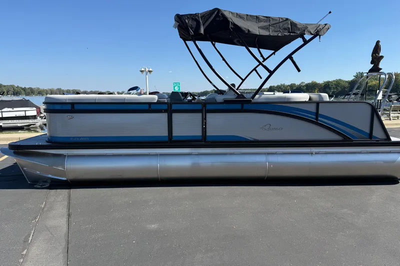 The Image of 2026 Qwest E-Class 22 Lanai pontoon boat with canopy, docked on a sunny day. - 1