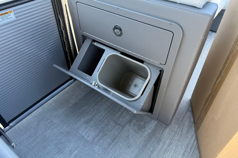 Slide: The Image of 2026 Qwest E-Class 22 Lanai interior with built-in storage compartment. - 17