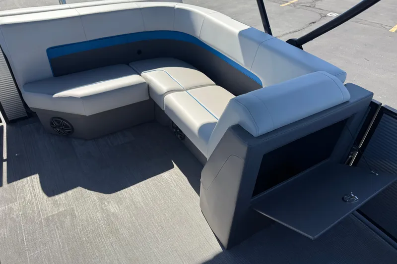 Slide: The Image of 2026 Qwest E-Class 22 Lanai boat interior with cushioned seating and storage compartment. - 18