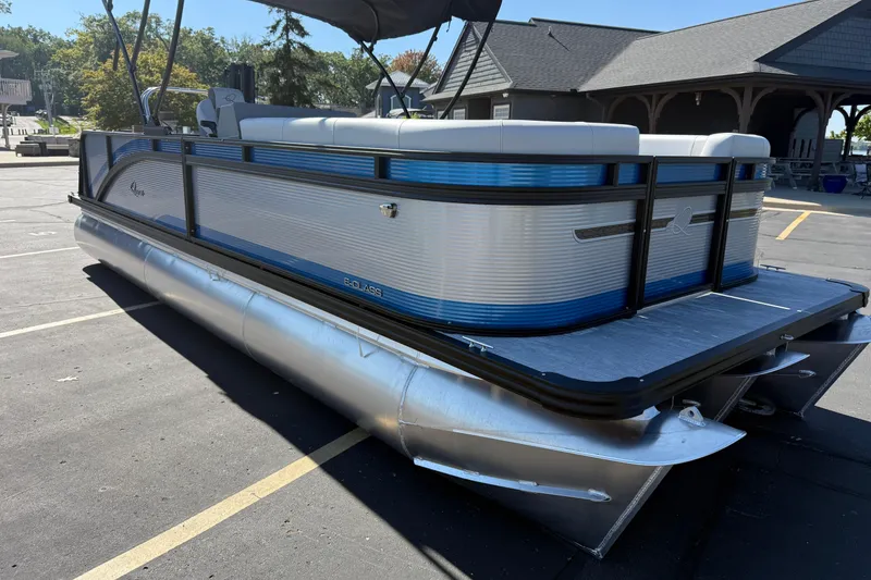 Slide: The Image of 2026 Qwest E-Class 22 Lanai pontoon boat parked, featuring sleek design and modern amenities. - 3