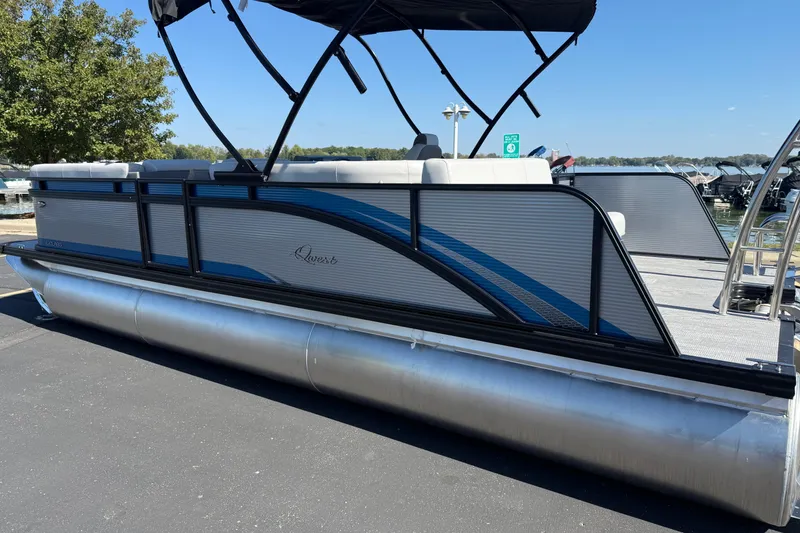 Slide: The Image of 2026 Qwest E-Class 22 Lanai pontoon boat docked under clear skies. - 8