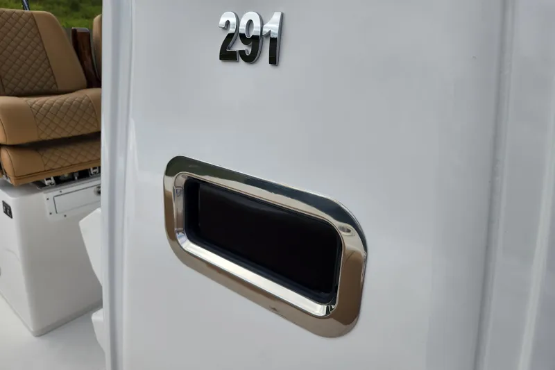 Slide: The Image of 2026 Caymas 291 boat interior with cushioned seating and sleek design details. - 14