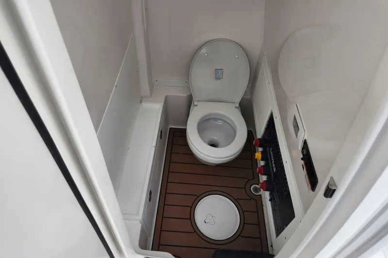 Slide: The Image of 2026 Caymas 291 boat interior bathroom with toilet and control panel. - 16