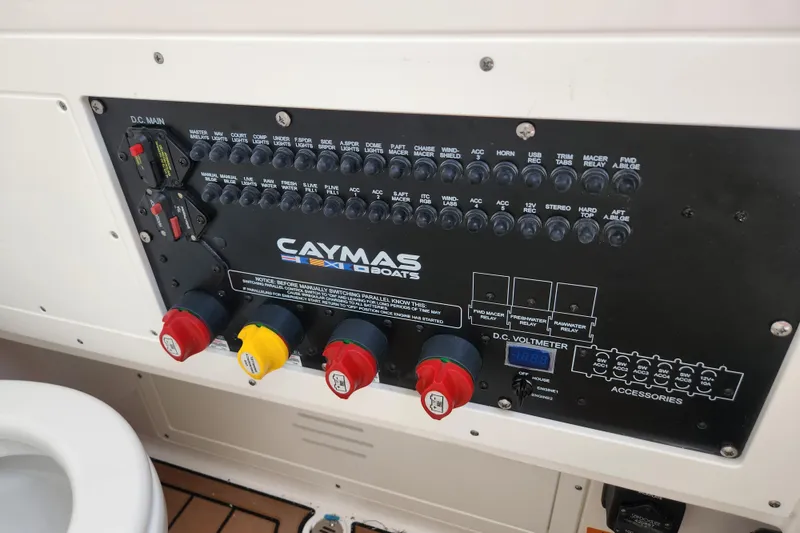 Slide: The Image of Control panel of 2026 Caymas 291 boat with switches and voltmeter display. - 17