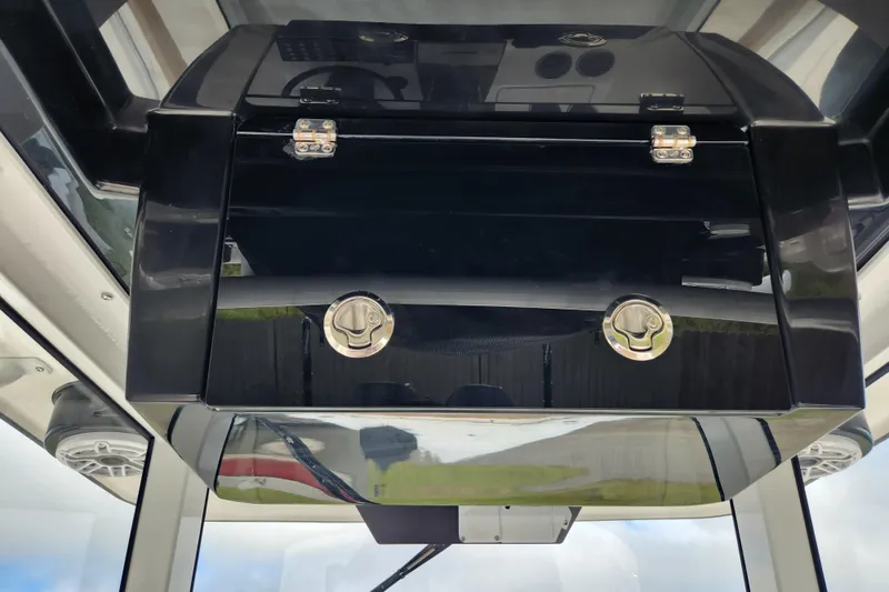Slide: The Image of 2026 Caymas 291 boat console with sleek black storage compartment and secure latches. - 30