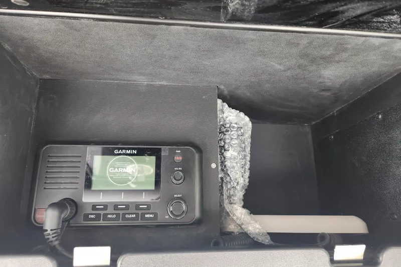 Slide: The Image of Garmin device in 2026 Caymas 291 boat compartment with bubble wrap packaging. - 31