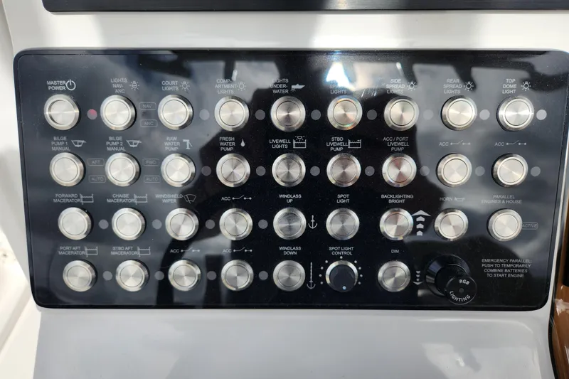 Slide: The Image of Control panel of a 2026 Caymas 291 boat with various switches and buttons. - 33