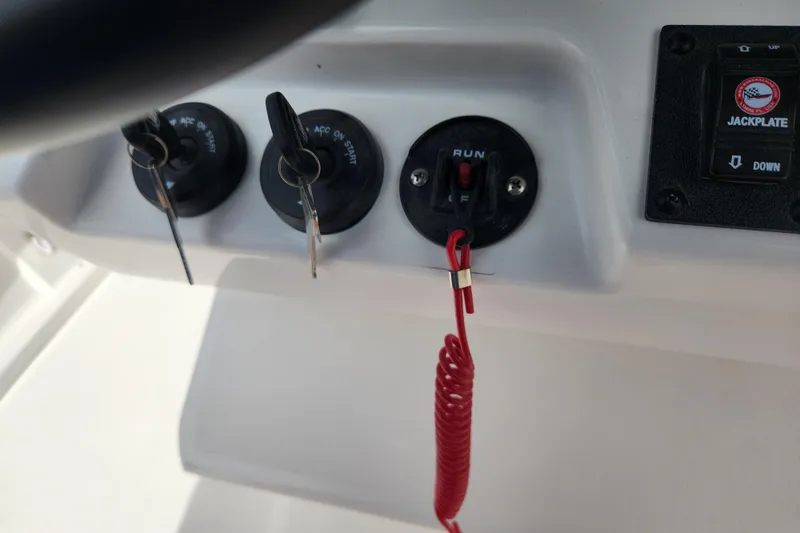 Slide: The Image of Control panel of 2026 Caymas 291 boat with ignition keys and safety switch. - 35