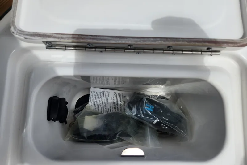 Slide: The Image of Open storage compartment in 2026 Caymas 291 boat, containing packaged items and accessories. - 36