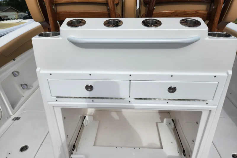Slide: The Image of 2026 Caymas 291 boat interior with storage drawers and cup holders. - 40
