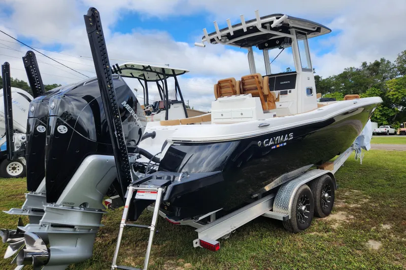 Slide: The Image of 2026 Caymas 291 boat on trailer, featuring dual Mercury engines and sleek design. - 51