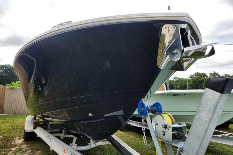 Slide: The Image of 2026 Caymas 291 boat on trailer, showcasing sleek hull design and anchor. - 54