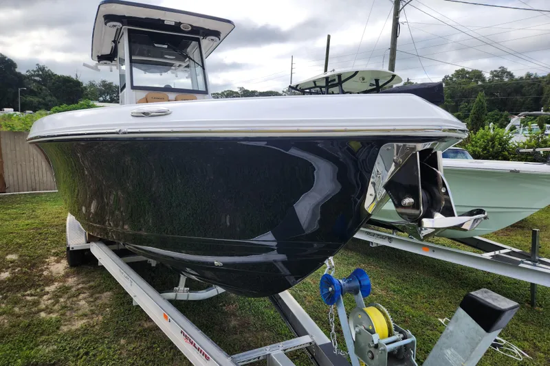 Slide: The Image of 2026 Caymas 291 boat on trailer, sleek design, parked outdoors. - 55