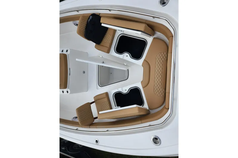 Slide: The Image of 2026 Caymas 291 boat interior with tan seating and storage compartments. - 7