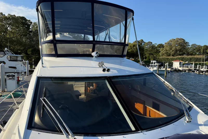 Slide: The Image of 2008 Sunseeker Manhattan 50 yacht docked at marina, showcasing sleek design and spacious flybridge. - 10